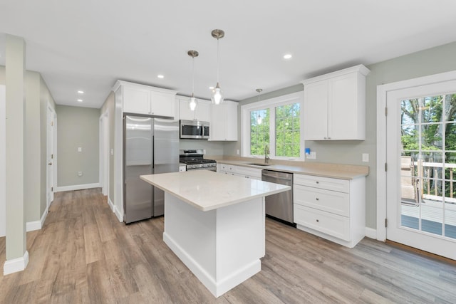 53 Richards Way, Farmington, NH 03835 - kitchen featuring stainless steel appliances, white cabinetry, light wood-style flooring, a center island, and recessed lighting