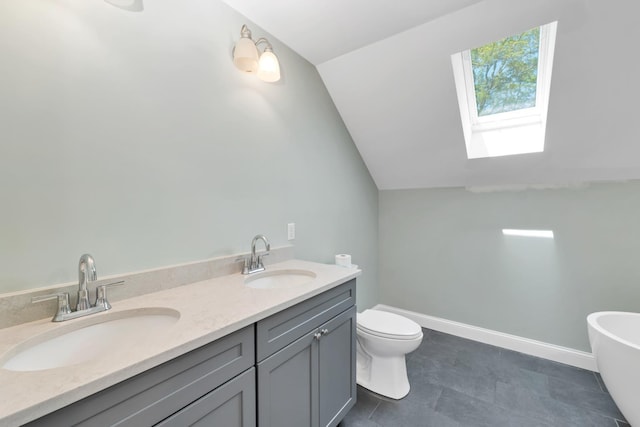 53 Richards Way, Farmington, NH 03835 - bathroom featuring lofted ceiling, a skylight, a freestanding bath, and double vanity