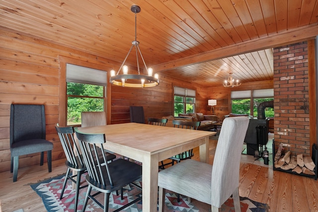 104 Rolling Ridge Rd, Bartlett, NH 03812 - dining space with a chandelier, a wood ceiling with exposed beams, wood finished floors, and wooden walls