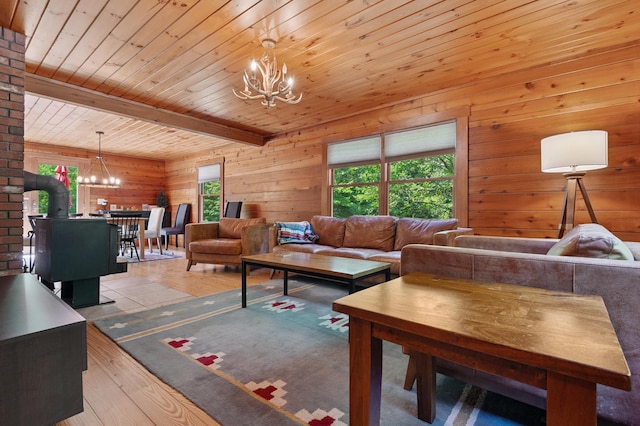 104 Rolling Ridge Rd, Bartlett, NH 03812 - living room with a chandelier, wood finished floors, wooden walls, and a wood ceiling with exposed beams