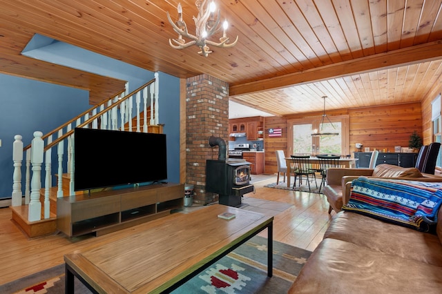 104 Rolling Ridge Rd, Bartlett, NH 03812 - living room with a chandelier, light wood-style flooring, stairs, a wood stove, and wood ceiling