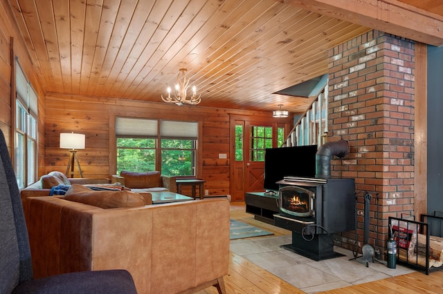 104 Rolling Ridge Rd, Bartlett, NH 03812 - living room with wood ceiling, healthy amount of natural light, a wood stove, a chandelier, and hardwood / wood-style flooring