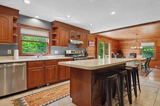 104 Rolling Ridge Rd, Bartlett, NH 03812 - kitchen with stainless steel appliances, open shelves, wooden walls, light countertops, and under cabinet range hood