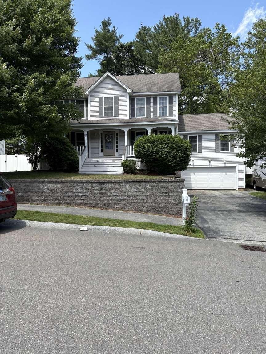 12 Hibiscus Way, Nashua, NH 03062 - view of front of property with asphalt driveway, a garage, and covered porch