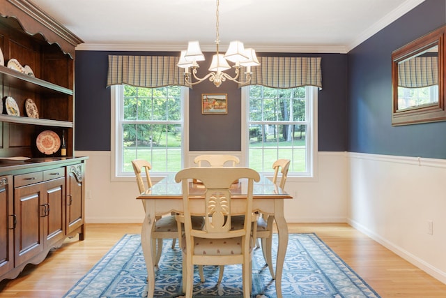 9 Deerhaven Dr, Exeter, NH 03833 - dining area featuring a chandelier, healthy amount of natural light, light wood finished floors, ornamental molding, and wainscoting