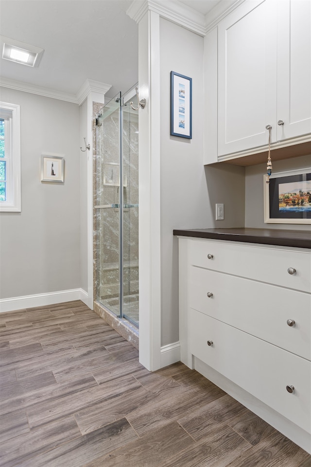 9 Deerhaven Dr, Exeter, NH 03833 - bathroom featuring a shower stall, crown molding, and wood finished floors