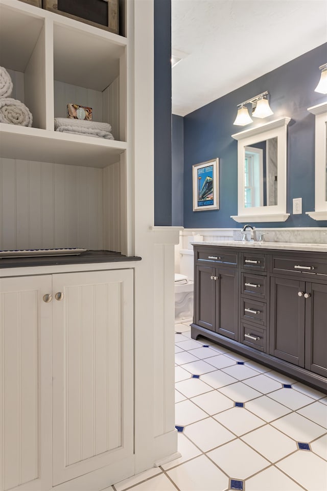 9 Deerhaven Dr, Exeter, NH 03833 - bathroom with vanity, wainscoting, and tile patterned floors