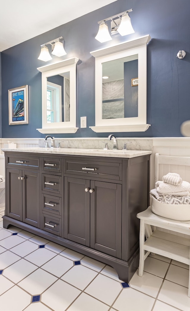 9 Deerhaven Dr, Exeter, NH 03833 - bathroom featuring double vanity, a wainscoted wall, and tile patterned flooring