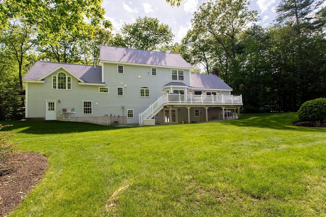 9 Deerhaven Dr, Exeter, NH 03833 - back of property featuring stairs, a wooden deck, a lawn, and a chimney