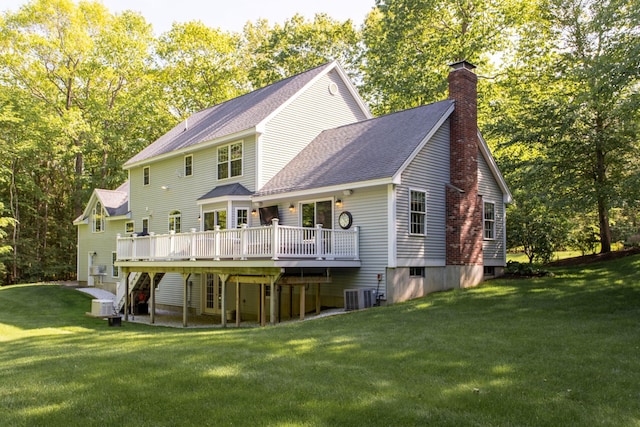 9 Deerhaven Dr, Exeter, NH 03833 - back of house with a chimney, a lawn, a wooden deck, and roof with shingles