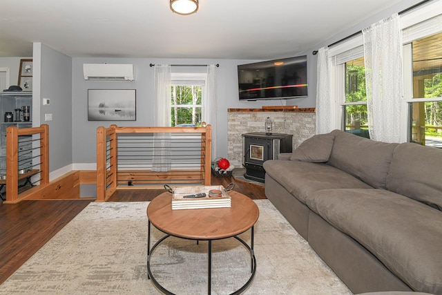 2129 E Conway Rd, Conway, NH 03813 - living room with a wall mounted air conditioner, wood finished floors, and a wood stove