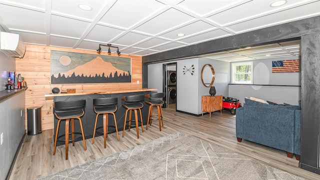 2129 E Conway Rd, Conway, NH 03813 - indoor dry bar featuring estacked washer and dryer, wooden walls, light wood-type flooring, an AC wall unit, and recessed lighting
