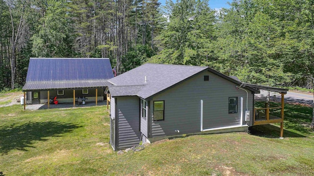 2129 E Conway Rd, Conway, NH 03813 - back of property featuring a lawn, a forest view, and a shingled roof