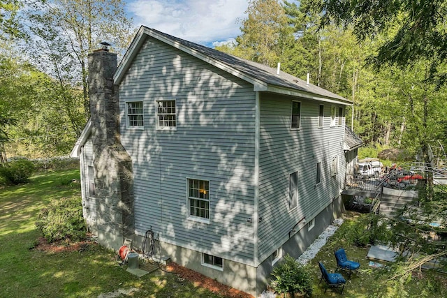 93 Birch Rd, Chester, NH 03036 - view of side of home with a chimney and a deck