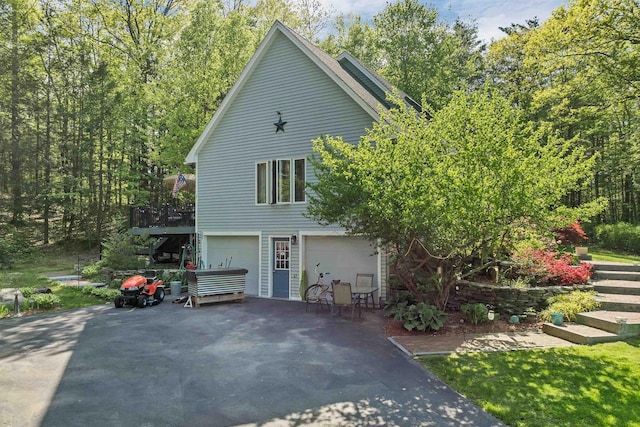 93 Birch Rd, Chester, NH 03036 - view of home's exterior featuring asphalt driveway, stairway, and a garage