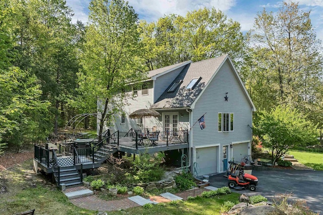 93 Birch Rd, Chester, NH 03036 - view of front of house featuring a deck, driveway, a garage, and a shingled roof