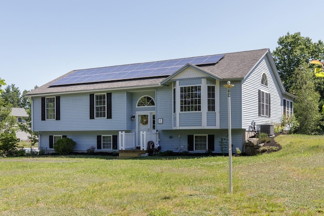 4 Lancer Ln, Danville, NH 03819 - bi-level home with solar panels, a front yard, and roof with shingles