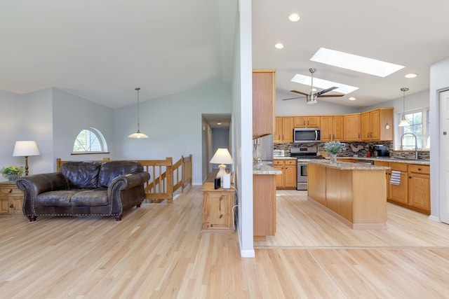 4 Lancer Ln, Danville, NH 03819 - kitchen featuring appliances with stainless steel finishes, a skylight, vaulted ceiling, open floor plan, and light wood finished floors