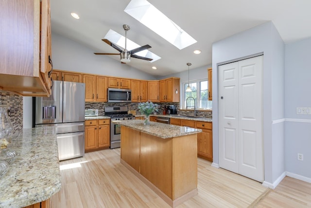 4 Lancer Ln, Danville, NH 03819 - kitchen featuring appliances with stainless steel finishes, a skylight, decorative backsplash, lofted ceiling, and light wood-style flooring