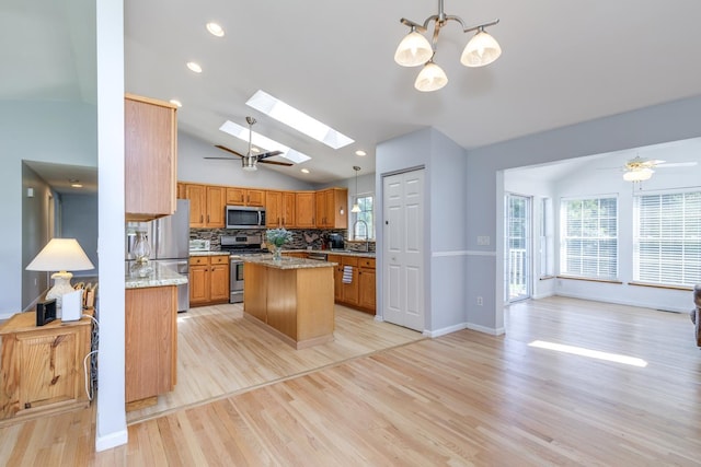 4 Lancer Ln, Danville, NH 03819 - kitchen featuring appliances with stainless steel finishes, lofted ceiling, light wood-type flooring, a skylight, and a center island