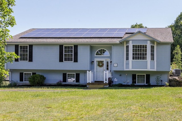 4 Lancer Ln, Danville, NH 03819 - bi-level home featuring solar panels, a front yard, and roof with shingles