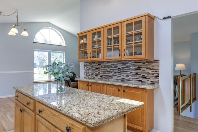4 Lancer Ln, Danville, NH 03819 - kitchen featuring light wood-style floors, light stone counters, tasteful backsplash, and lofted ceiling