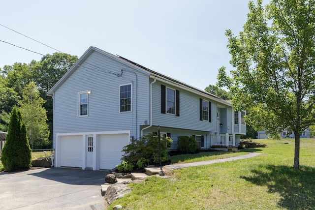 4 Lancer Ln, Danville, NH 03819 - view of front of property with an attached garage, asphalt driveway, and a front lawn