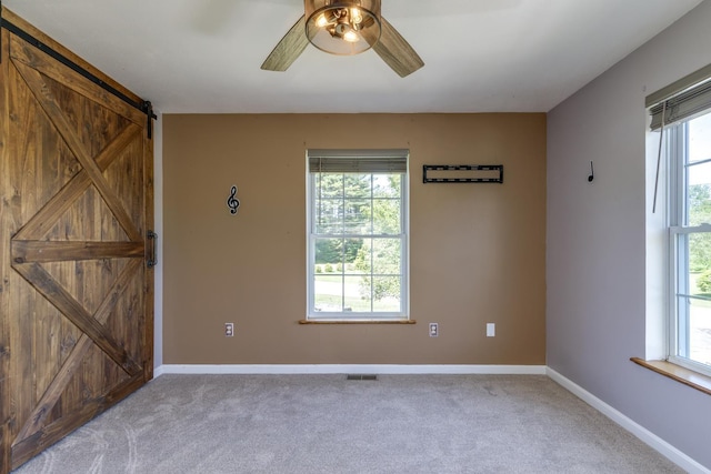 4 Lancer Ln, Danville, NH 03819 - carpeted spare room with a barn door, ceiling fan, and healthy amount of natural light