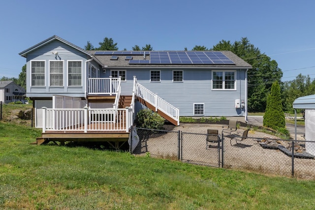 4 Lancer Ln, Danville, NH 03819 - rear view of house featuring a deck, solar panels, a fenced backyard, a gate, and roof with shingles