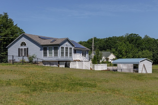 4 Lancer Ln, Danville, NH 03819 - back of property with roof mounted solar panels, a sunroom, a carport, and a shingled roof
