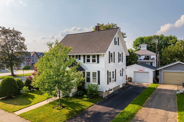 71 Hill St, Dover, NH 03820 - view of front of house with a garage, an outdoor structure, a chimney, a shingled roof, and a front lawn