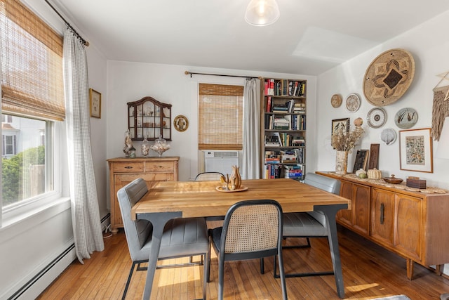 71 Hill St, Dover, NH 03820 - dining area featuring baseboard heating, light wood-style floors, and cooling unit