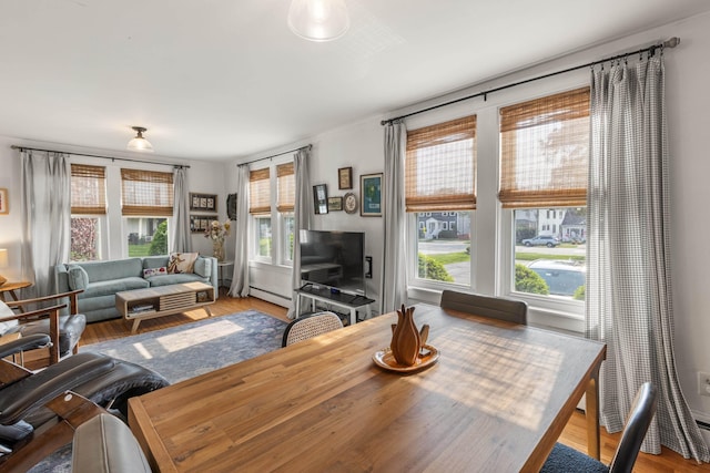 71 Hill St, Dover, NH 03820 - dining area featuring baseboard heating, healthy amount of natural light, and wood finished floors