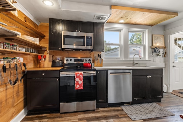 71 Hill St, Dover, NH 03820 - kitchen featuring appliances with stainless steel finishes, dark wood finished floors, dark cabinetry, light countertops, and recessed lighting