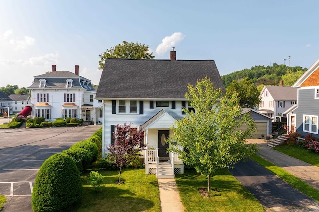 71 Hill St, Dover, NH 03820 - view of front of home featuring a chimney, a front yard, and a shingled roof