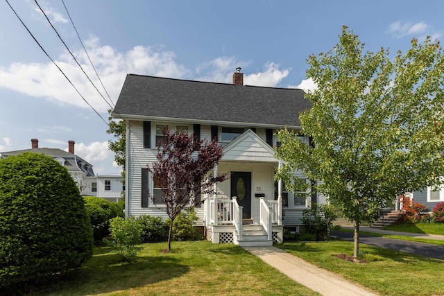 71 Hill St, Dover, NH 03820 - view of front of home with a front yard, a chimney, and roof with shingles