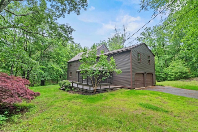 147 Durham Point Rd, Durham, NH 03824 - view of grassy yard with driveway, a garage, and a deck