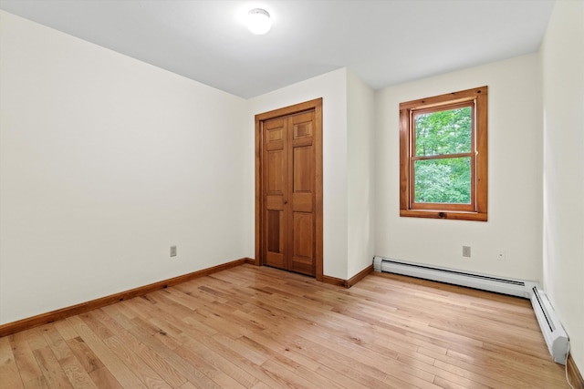 147 Durham Point Rd, Durham, NH 03824 - spare room featuring a baseboard radiator and light wood-style flooring