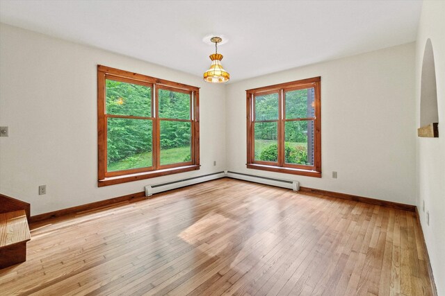 147 Durham Point Rd, Durham, NH 03824 - unfurnished room featuring arched walkways, baseboard heating, and hardwood / wood-style flooring