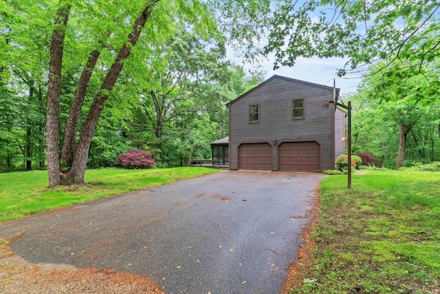 147 Durham Point Rd, Durham, NH 03824 - view of property exterior featuring asphalt driveway, an attached garage, and a lawn