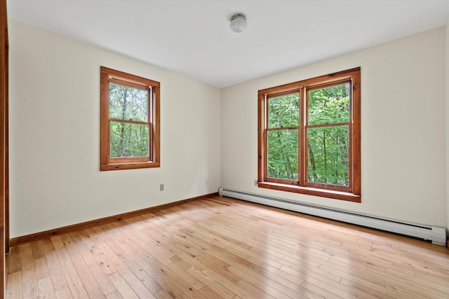 147 Durham Point Rd, Durham, NH 03824 - empty room with a baseboard heating unit and wood-type flooring