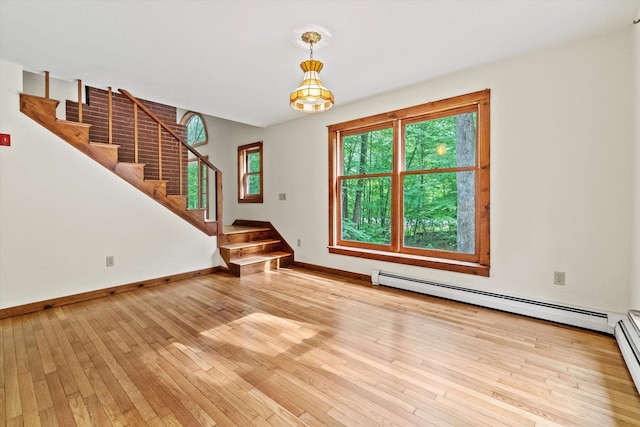 147 Durham Point Rd, Durham, NH 03824 - unfurnished living room featuring baseboard heating, stairs, and light wood-style flooring
