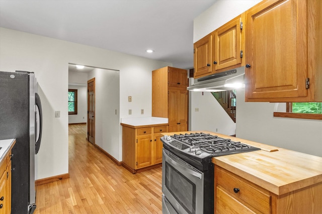 147 Durham Point Rd, Durham, NH 03824 - kitchen featuring stainless steel appliances, light wood-style flooring, under cabinet range hood, brown cabinetry, and recessed lighting