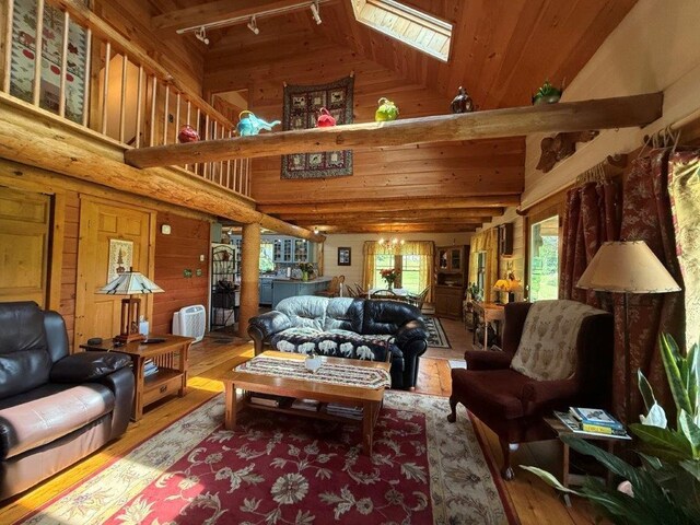 25 Rogers Way, Canaan, NH 03741 - living area with wood-type flooring, high vaulted ceiling, rail lighting, a skylight, and wooden ceiling