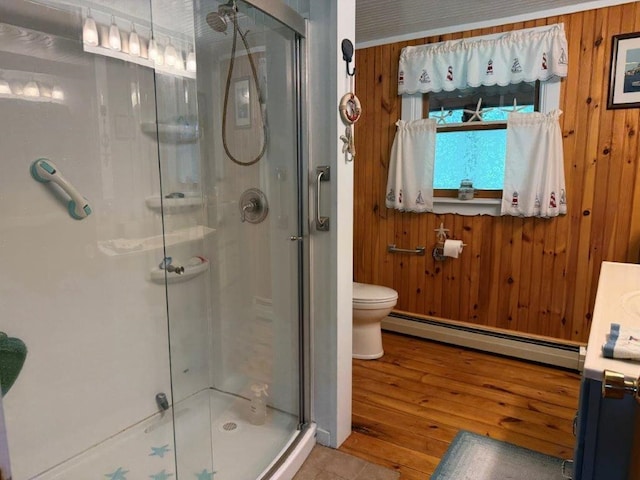 25 Rogers Way, Canaan, NH 03741 - bathroom with a baseboard heating unit, wooden walls, a shower stall, and wood finished floors