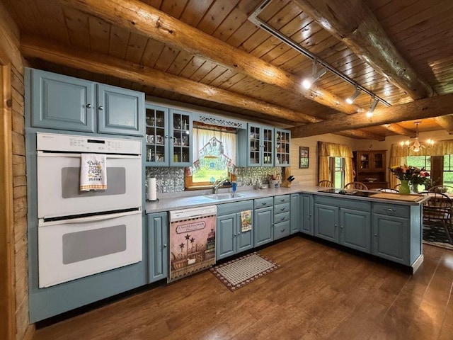 25 Rogers Way, Canaan, NH 03741 - kitchen featuring double oven, dishwashing machine, a peninsula, a wooden ceiling with exposed beams, and a chandelier