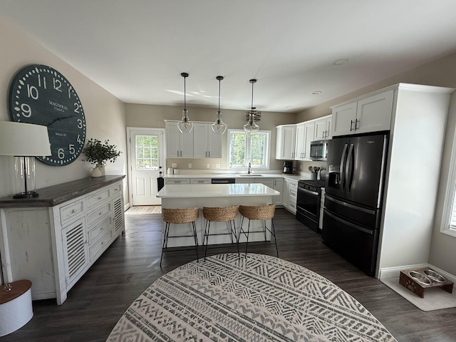 3800 Province Lake Rd, Wakefield, NH 03830 - kitchen featuring fridge with ice dispenser, stainless steel microwave, range with gas stovetop, a kitchen island, and white cabinetry