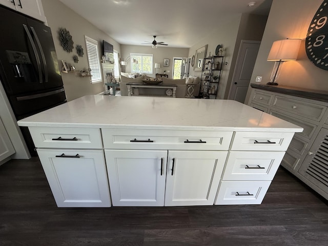 3800 Province Lake Rd, Wakefield, NH 03830 - kitchen with black fridge with ice dispenser, ceiling fan, light stone countertops, dark wood finished floors, and white cabinetry