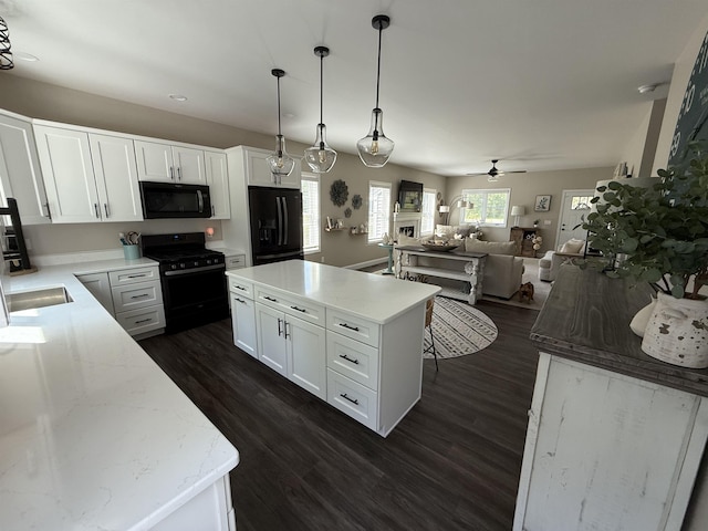 3800 Province Lake Rd, Wakefield, NH 03830 - kitchen with black appliances, a ceiling fan, open floor plan, dark wood-type flooring, and white cabinets