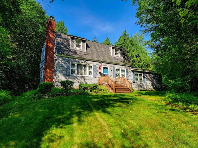 6 Cypress Ln, Essex, VT 05452 - view of front facade with a chimney, a front lawn, and a wooden deck